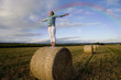 Girl standing in hay bale