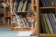 Photo: Girl reading a book in library Girl reading a book in library