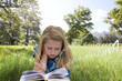 Girl reading a book in the grass