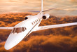 Airplane flying over orange clouds