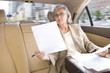 Businesswoman riding in town car
