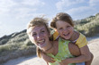 Portrait of mother piggybacking daughter