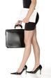 long legs of sensual business woman with black suitcase