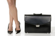 long legs of sensual business woman with black suitcase