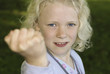 Young blond girl showing her fist
