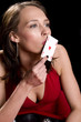 Attractive brunette dressed in a red dress kissing the ace Attractive brunette dressed in a red dress kissing the ace