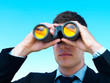 Closeup of a young business man looking through binoculars Closeup of a young business man looking through binoculars