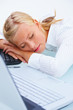 Young beautiful business woman sleeping at office desk