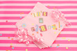 cut out letters spelling it's a party on pink napkins