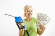 Photo: Happy woman with gas pump and money. Happy woman with gas pump and money.