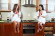 Sexy young adult brunette roommates in lingerie drinking