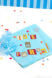 cut out letters spelling it's a party on baby blue napkins