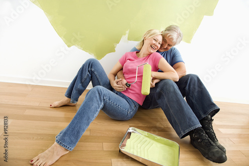 Photo: Happy couple with painting supplies Happy couple with painting supplies