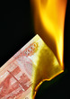 5000 russian rubles bill on fire over black background
