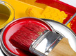 Red and yellow paint can and brush and roller Red and yellow paint can and brush and roller