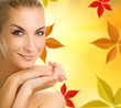 Beautiful young woman over abstract autumn background