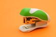 modern stapler on orange background