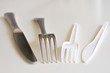Inox knife and fork with white plastic ones