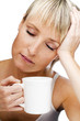 young blond woman with cup of coffee early in the morning