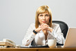 Young beautiful business lady at desk thinking.