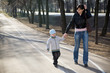 Mother and her son walking in a park