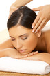 Beautiful brunette woman taking head massage
