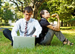 two businesspeople have a break at the grassland two businesspeople have a break at the grassland