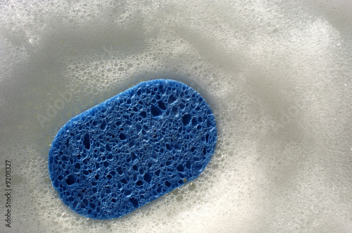 Blue sponge with soap bubbles Blue sponge with soap bubbles