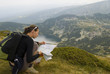 Resting mountaineer is reading a map
