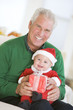 Grandfather With Baby In Santa Outfit