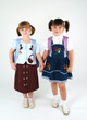 cute happy school girls holding hands