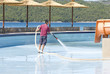 a man washing swimming pool