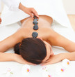Woman receiving hotstone massage at spa Woman receiving hotstone massage at spa