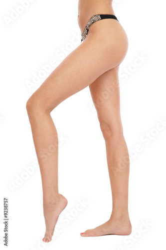 Photo: Slim long legs and hips of sexy tanned barefoot woman Slim long legs and hips of sexy tanned barefoot woman