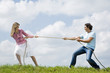 Couple pulling rope, close-up