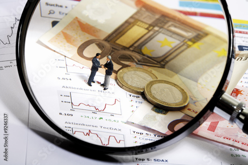 Photo: Magnifying glass, Euros and figurines Magnifying glass, Euros and figurines