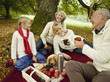 Photo: Germany, Baden-Württemberg, Swabian mountains, Three generation family having picnic in forest Germany, Baden-Württemberg, Swabian mountains, Three generation family having picnic in forest