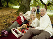Photo: Germany, Baden-Württemberg, Swabian mountains, Three generation family having picnic in forest Germany, Baden-Württemberg, Swabian mountains, Three generation family having picnic in forest