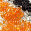Red and black caviar on crushed ice, close-up