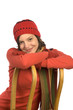 Young woman leaning on sledge, smiling, portrait