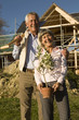 Senior couple gardening, smiling, portrait, low angle view