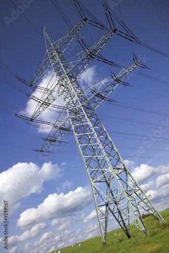 Photo: Electricity pylon in meadow, low angle view Electricity pylon in meadow, low angle view