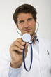 Male doctor holding stethoscope, close-up, portrait