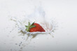 splashing strawberry into a milk splashing strawberry into a milk