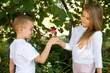 preshool boy is givinga rose flower to his girlfriend