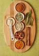 a variety of spices on a bamboo board