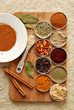 a variety of spices on a bamboo board