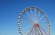 Ferris wheel on background blue sky