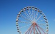 Ferris wheel on background blue sky