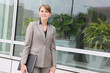 A pretty business woman outside office building